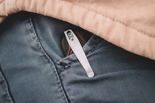 Minimalist folding city EDC knife held in hand