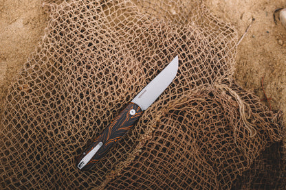 Knife with a decorative handle on a textured brown surface