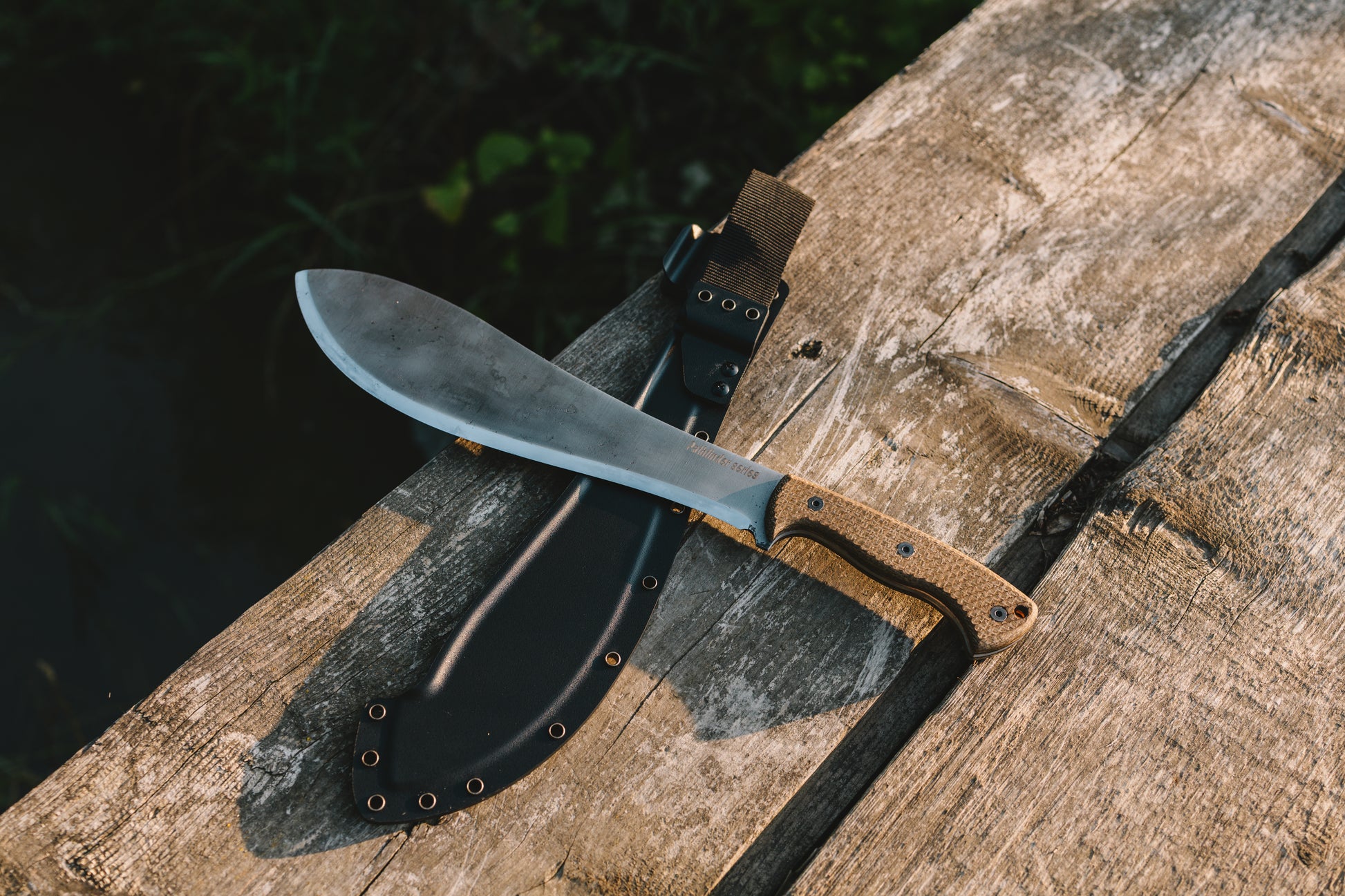 Bamboo knife with sheath on a wooden surface