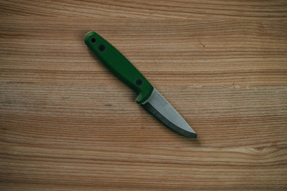 Small knife with a green handle on a wooden surface