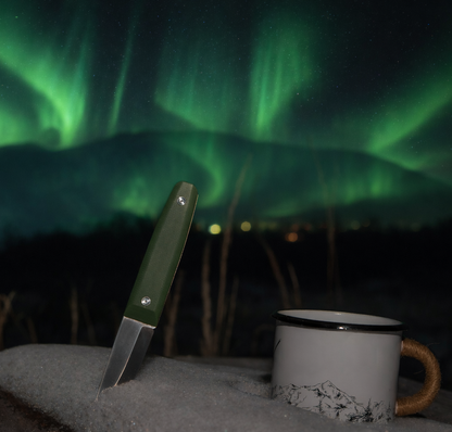 Knife and mug with Northern Lights in the background